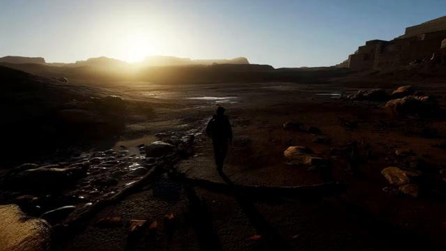 The video shows a person walking through a post-apocalyptic scene, with the camera capturing them from above as they slowly move forward under the sunlight in a wasteland-style setting.